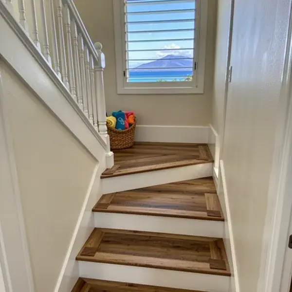 Stairs redone in wood-look vinyl after the carpet Converted stairs with luxury vinyl treads in Kahana home