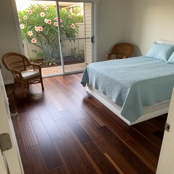 Flat, solid engineered planks over a prepped slab Engineered walnut floor in ground floor Kihei condo bedroom