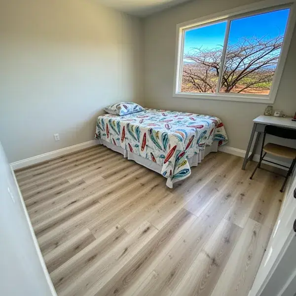 Floating laminate floor over slab in Kihei bedroom