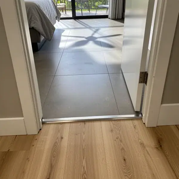 Flush tile to vinyl plank transition in Wailuku condo