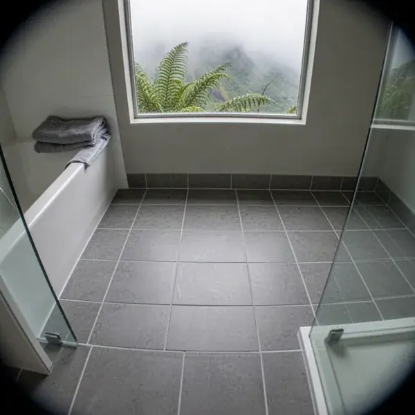 Freshly regrouted gray tile floor in Olinda bathroom