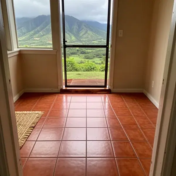Replacement tiles blending into an older entry Repaired ceramic tile entry floor in older Wailuku home