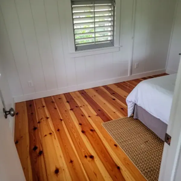 Solid fir boards in an upstairs bedroom Squeak-free hardwood floor in raised Paia plantation home